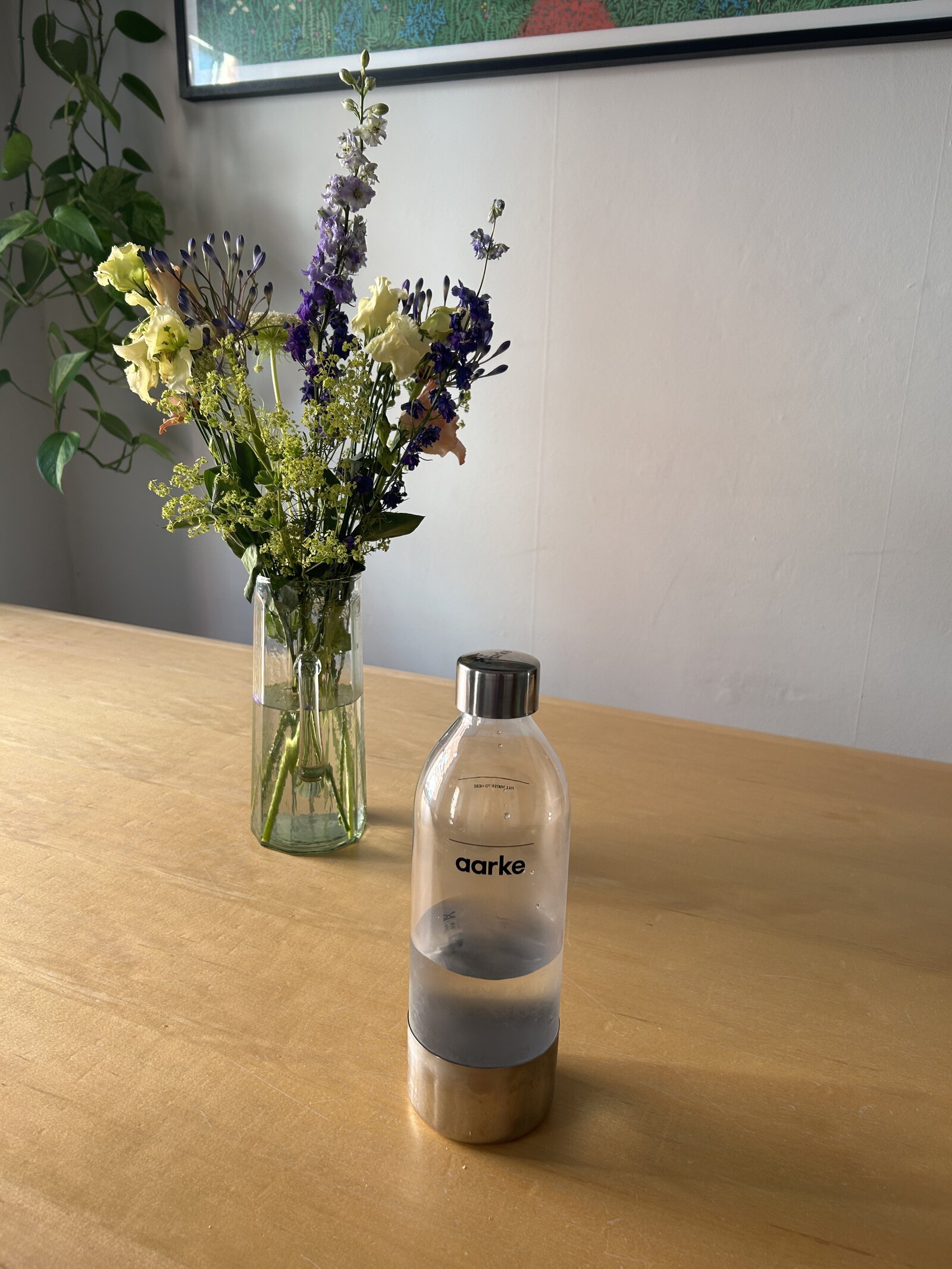 Aarke PET bottle out on the dining table next to a vase of flowers