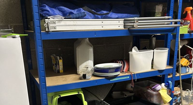 BiGDUG blue heavy-duty garage shelving loaded with tools and storage