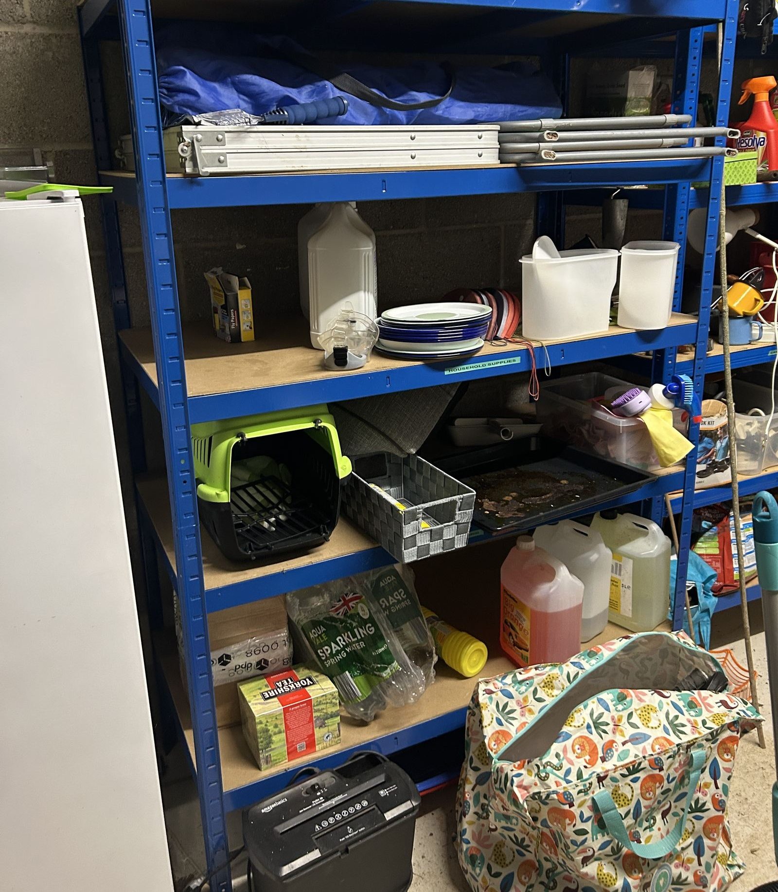 BiGDUG blue heavy-duty garage shelving loaded with tools and storage