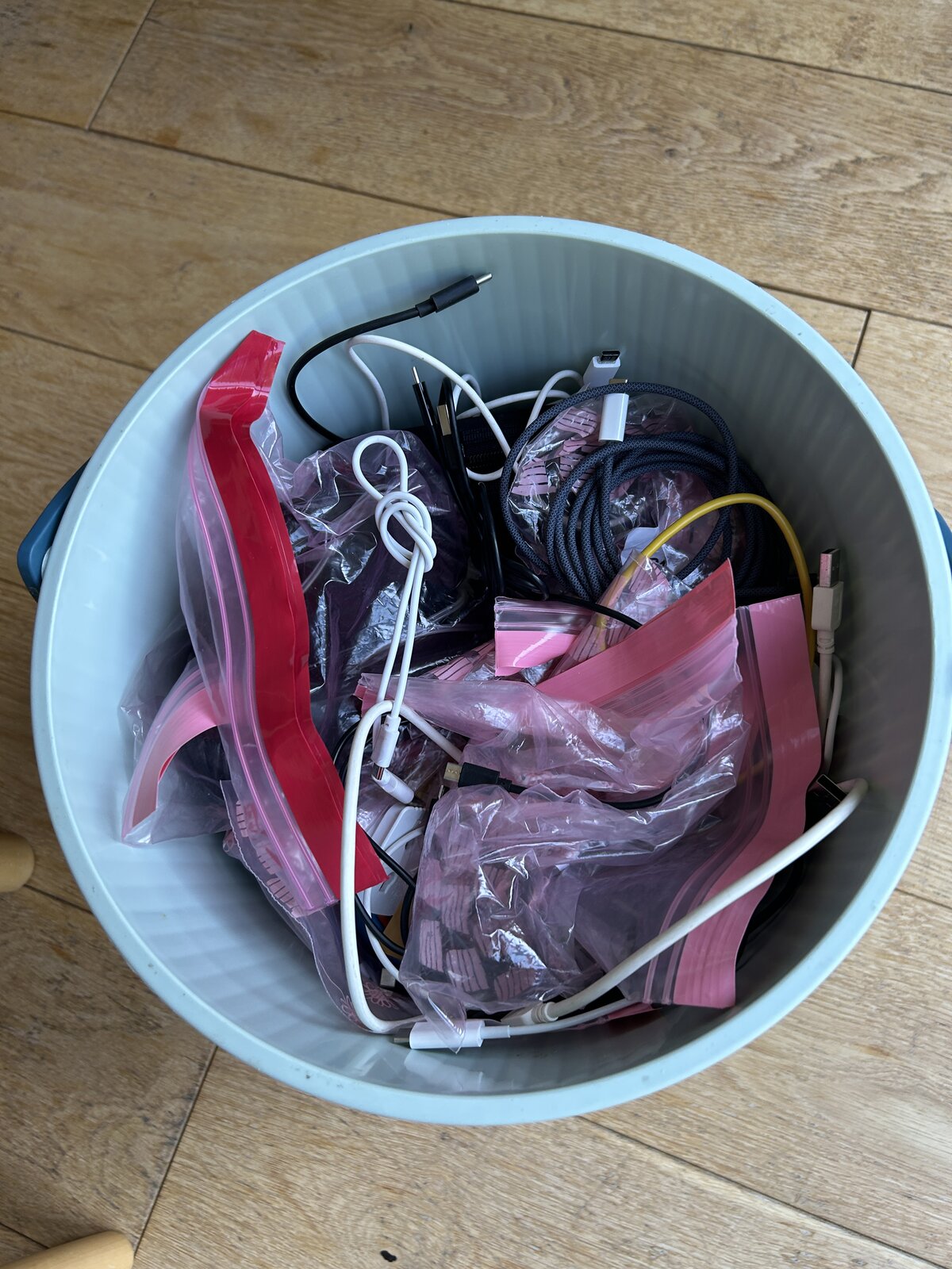 The blue Hachiman bucket full of tangled cables and bagged-up bits