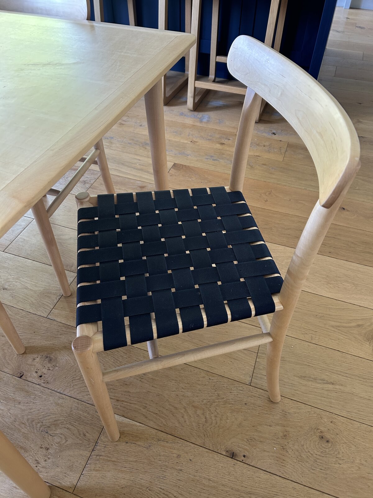 Close-up of the woven black webbing on a Lightwood chair seat
