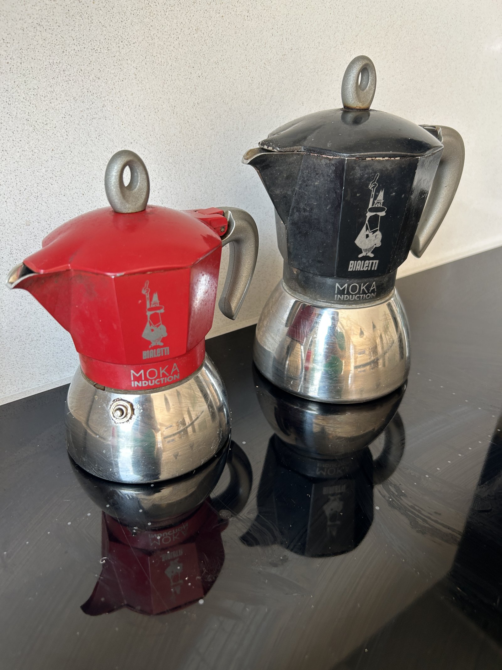 The red Bialetti four-cup Moka Induction pot on the hob