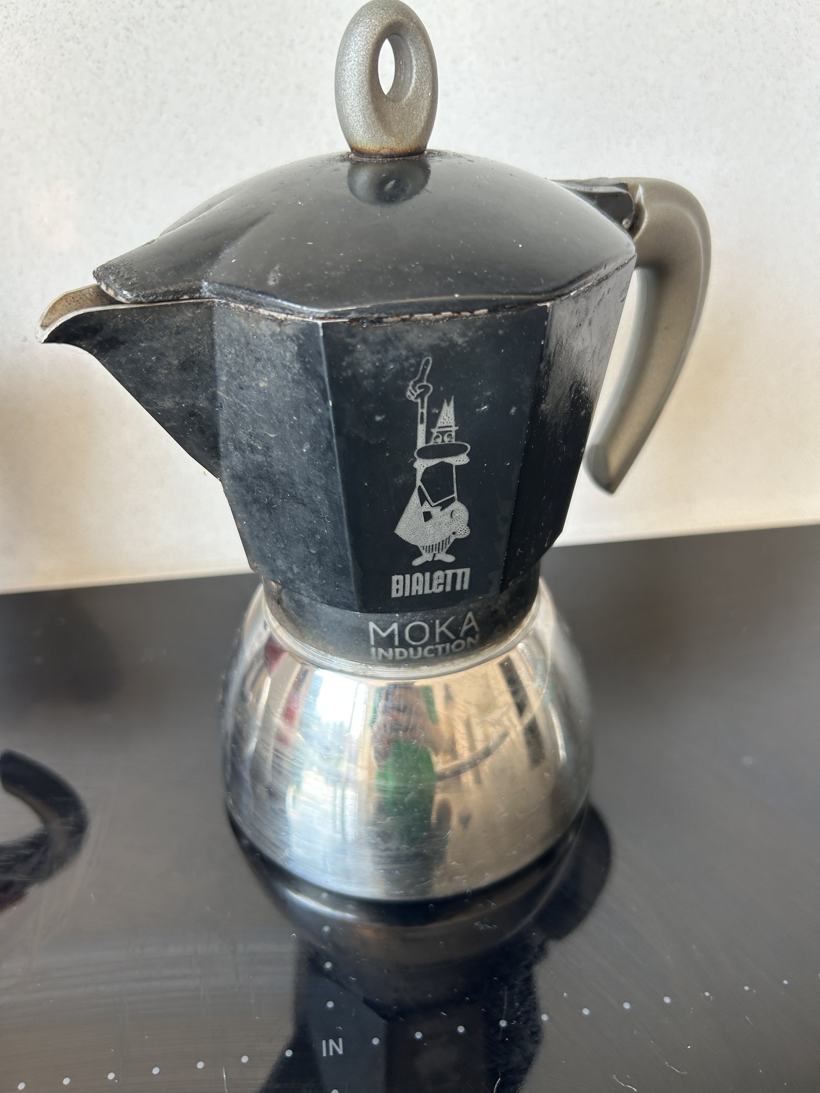 The black Bialetti six-cup Moka Induction pot on the hob