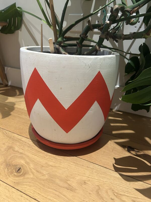 Close-up of the Pow Pots pot, showing the red and white zigzag pattern
