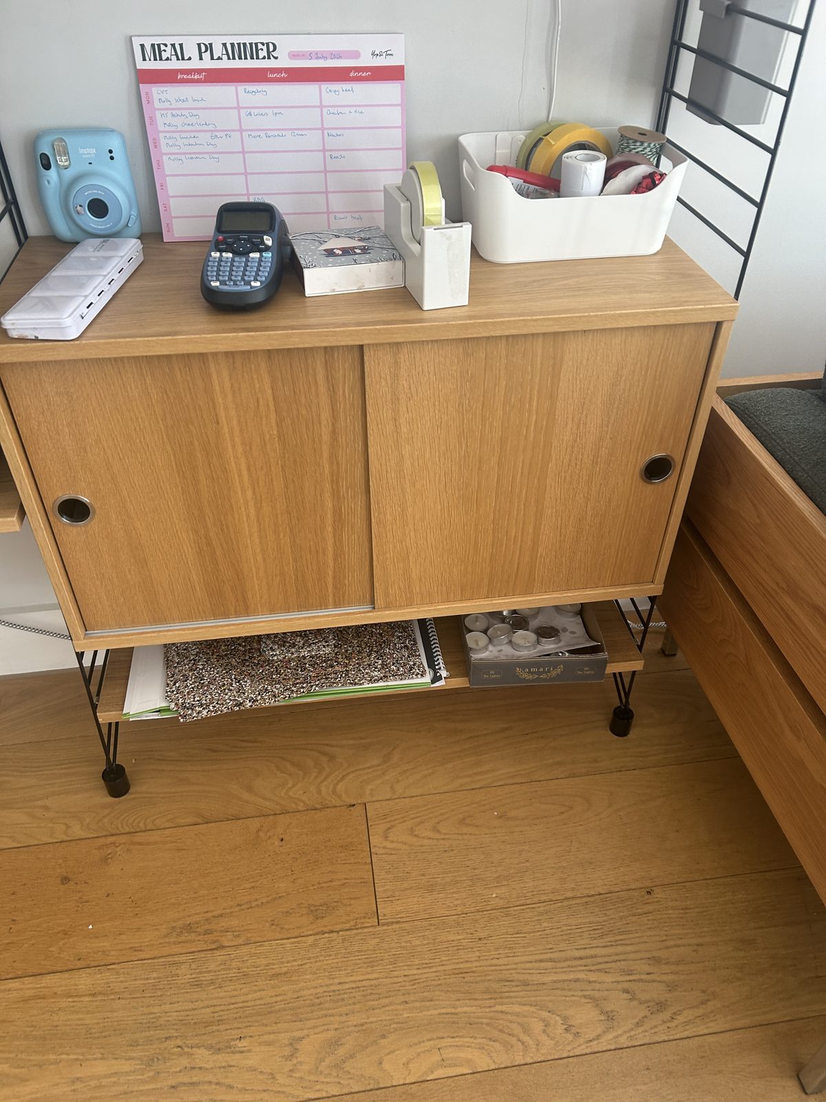 Top of the String cabinet with meal planner, camera and everyday clutter