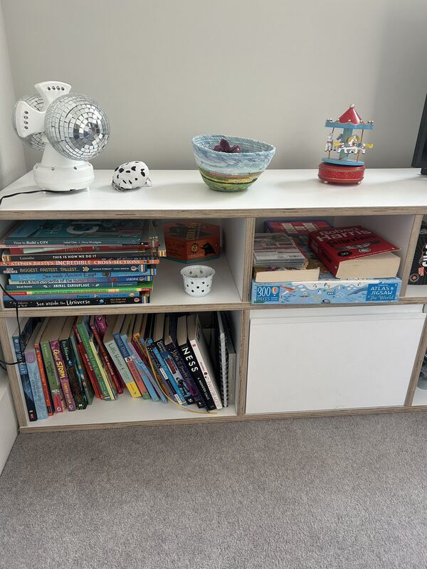Close-up of the Tylko shelf top, with books, games and odds and ends